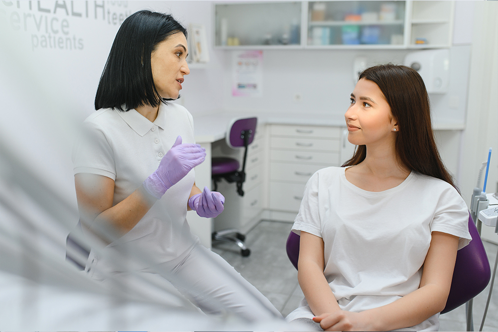 Patient discussing a dental implant treatment plan and tooth replacement options with a dentist.